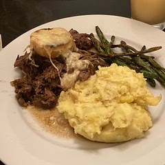 I added a good splash of red wine (1/4 cup) & a packet of onion soup mix to the broth. 
We all think it was the best pot roast ever!