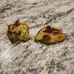 In the picture - the one on the left is made into ball.
The one on the right i flattened. 
The ball is not crispy and is soggy in the middle. 
The flat is crispier and not soggy. 
 This recipe makes a lot. Will not be making make again. If you try, use a whole onion, add much more seasoning and get a cheese cloth to release water in onion and zucchini 