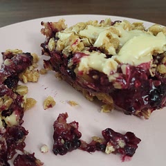 I halved this recipe, used ~13 ounces of homegrown previously frozen and thawed black raspberries, and baked in an 8×8 pan. I microwaved a couple ounces of white chocolate chips with a tbsp or 2 of cream to add a drizzle on the top after it had a chance to cool for a little bit. Incredibly good and will absolutely be making again.