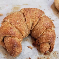 I couldn't find the baking temperature so I looked up a couple of other recipes and ended up baking them at 400 degrees Fahrenheit for 18 minutes. I am at 5000 feet elevation. Flavor is very good, I received three compliments. Some came back for thirds. Size is small to very small. I tried to make it 100% whole wheat and natural yeast. I think that 100% whole wheat needs a different technique than this recipe. 
