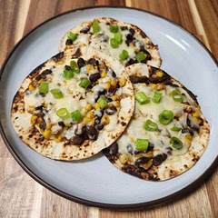 Super tasty with some small adjustments: I bought canned "mexican steeet corn" instead of just normal corn, I added on my favorite hot sauce into the corn/bean mix, and put some green onion on top for garnish. I ended up turning them into tostadas instead of quesadillas. I would definitely make these again!