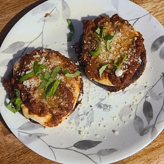 I always sweat the eggplant. I pan-fried the eggplant (corn starch, then egg (with milk) and then italian breadcrumbs with a slice of fresh mozzarella between the eggplant and the sauce.  I baked with fresh grated parmesan / reggiano cheese on top for about 18 mins (high altitude).  DELICIOUS!   Will definitely make it again.