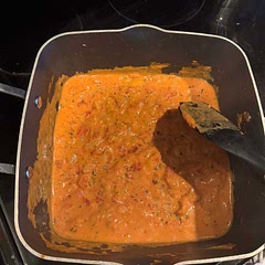 I cooked the chicken in the oven and made the sauce in a pan. 
Added a lot of garlic cloves, 1/4 cup chicken broth, fire roasted diced tomatoes, spaghetti sauce, red pepper flakes and cream cheese.  Served with noodles.