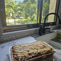 I made Mexican lasagna for a group of expats living along Riviera Maya in Quintana Roo, Mexico. My pan looks like it may overflow during cooking. Next time, I will use 1 less layer and reserve leftover sauce and cream filling for another meal.
I was worried that the cream layer would be difficult to spread, but it wasn't at all. It came together easily. 
