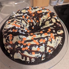 Cake can also be made in a Bundt pan for a different look. In my version, I did a cream cheese frosting, drizzled with chocolate syrup, and topped with sprinkles.