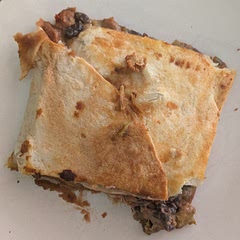 Used this recipe as an instructional base for my own fillings (8oz sharp cheddar shredded from the block, 14oz canned black beans, 4oz canned diced green chilis, 31oz canned refried beans, homemade blend of fried onions & peppers [1 onion, 1 green bell pepper, 1 red bell pepper], and homemade taco seasoning [cumin, smoked paprika, coriander, salt]) but followed the instructions exactly and this came out perfectly cooked.

My one note is that the recipe calls for ten 8" tortillas for a 9x13" pan and I only needed seven! I wonder if the original recipe expects more overlap but 7 tortillas (5 on bottom, 2 on top) kept all the fillings perfectly held with no bursting/spillage. I also cut this into 8 portions so that one portion is a meal as opposed to a snack as the original recipe portions out to very small pieces. Absolutely will make this again with these sizing adjustments in mind though!