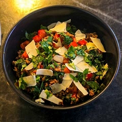 Savory Ground Beef & Vegetable Warm Bowl. A comforting mix of seasoned ground meat tossed with tender sautéed greens, diced sweet peppers, and fresh cilantro, topped generously with shaved Parmesan cheese.