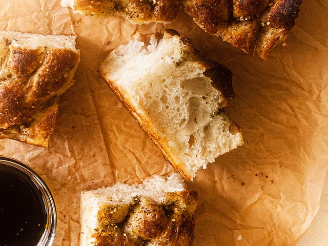 Don't overwork the dough! :) Over kneaded dough will result in rock-hard focaccia. The mark of good focaccia is the air pockets you see in the crumb. Try out this recipe: fluffy inside, crispy outside. :)