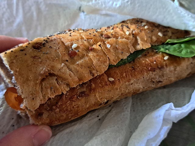 Smoked salmon sandwich with baby spinach and lactose free cheese spread in whole grain bread with flax seeds, poppy seeds, sesame seeds... and other seeds that I don't know. 😅 does it count?