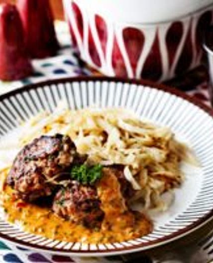 Keto hamburger patties with creamy tomato sauce and fried cabbage
