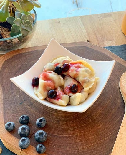 Vareniki / Pierogi with potatoes and mushrooms or cherries and blueberries