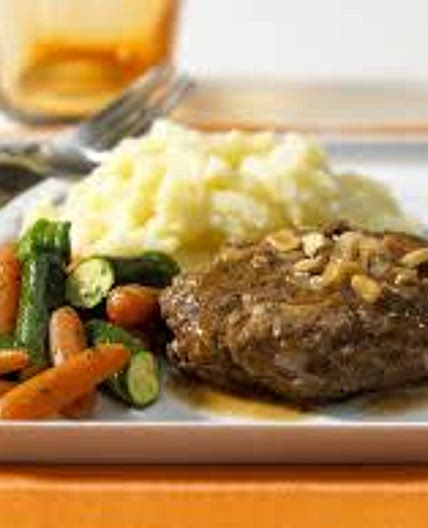 Meatball patties with mashed potato, roast carrots and brussels
