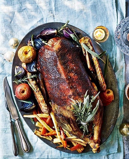Roast goose with roast apples and onions and potato stuffing