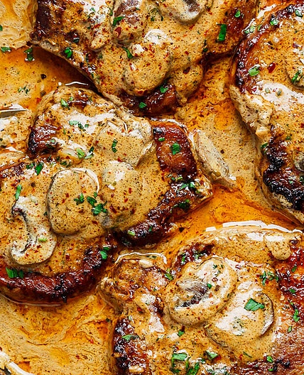 Pork chops in creamy garlic mushroom sauce