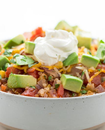 Tex-Mex Quinoa Vegetable Stew with avocado and cheddar-jack cheese