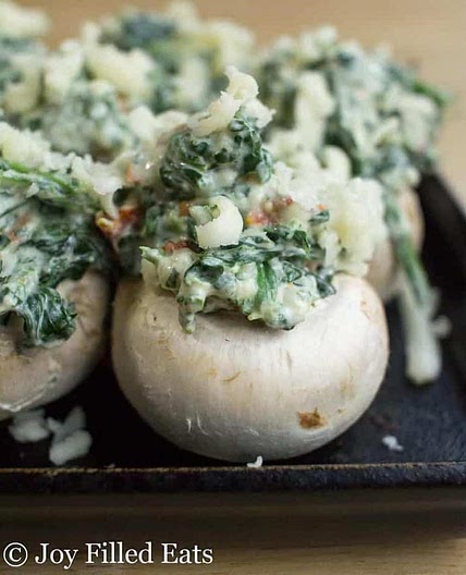 Spinach Stuffed Mushrooms with Garlic, Sun Dried Tomatoes, & Cheese