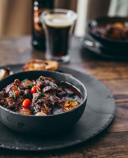 Porter oxtail potjie with braaied spuds - Yuppiechef Magazine