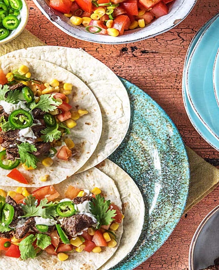 One-Pan Steak Fajitas With Tomato Corn Salsa, Cilantro, and Sour Cream