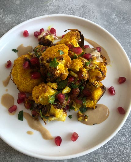 Turmeric roasted cauliflower with pomegranate and tahini