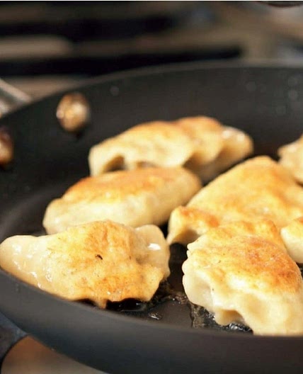Pierogi with potatoes, cheese, bacon, and pea filling.