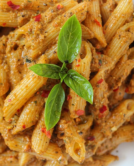Vegan pasta with olives and tomato pesto.