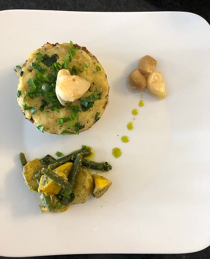 Shredded confit  duck with mashed potato rounds and garlic conf