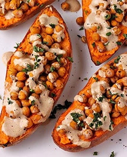 Loaded baked sweet potatoes with lemon-tahini dressing