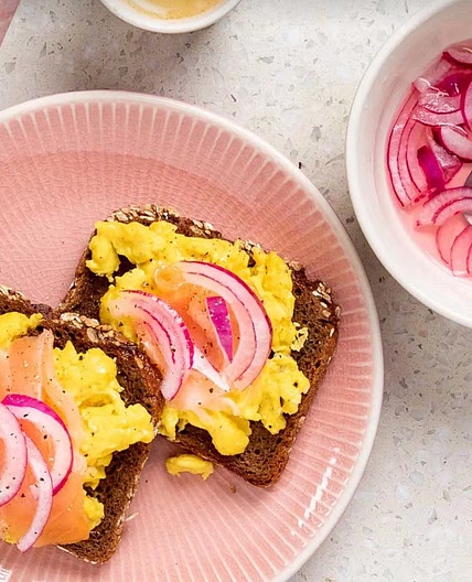Smoked salmon and scrambled egg
 on toast with red onion pickle