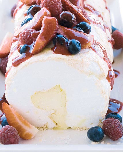 Soft pavlova roll with liqueur mascarpone and berry compote