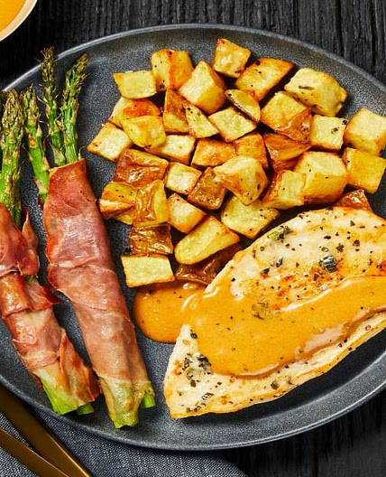 Buttery Garlic-Herb Chicken with Prosciutto-Wrapped Asparagus & Herbed Potatoes