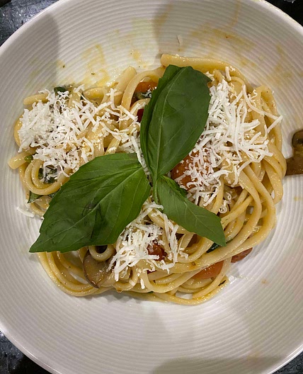 Confit cherry tomato and garlic pasta with mushrooms