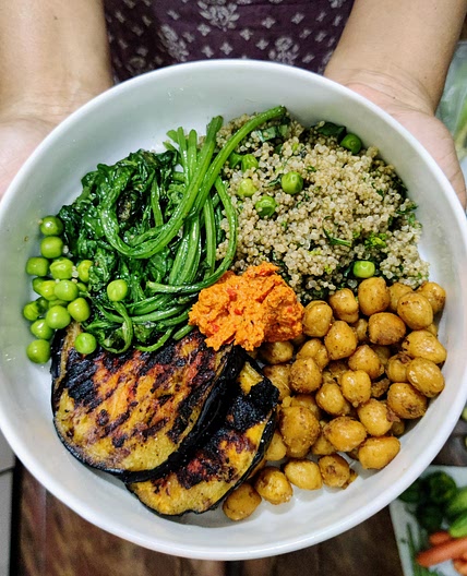 Buddha bowl with basil pea quinoa, romesco aubergine, chickpeas and spinach