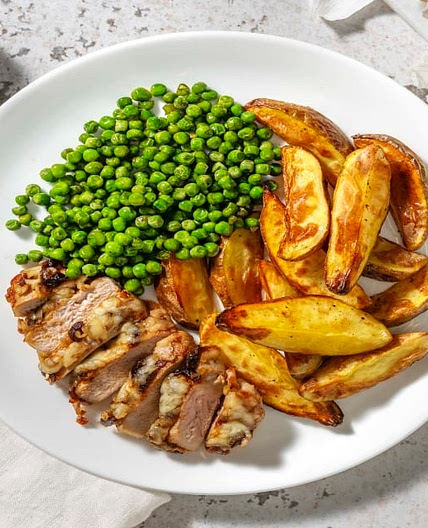 Cheese and Caramelised Onion Pork Steaks with Wedges and Peas