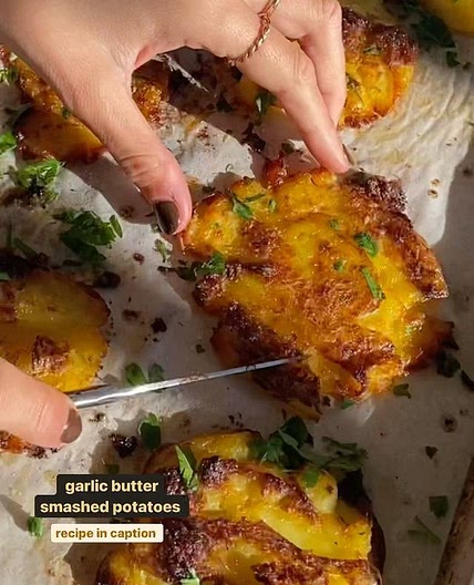 crispy smashed potatoes, recipe below 1 head garlic 1 tbsp olive oil 1kg baby white potatoes 90g butter 2 1/2 tbsp olive oil, extra Salt, to taste 2 tbsp parsley, finely chopped. Preheat oven to 200C. Chop the top off the head of garlic. Place on top of a 