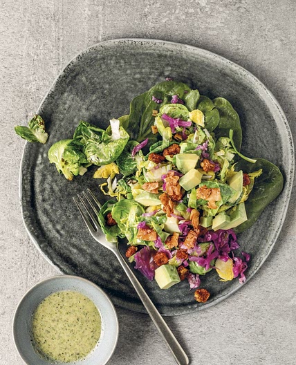 Warm Brussels Sprouts Salad with Capers, Coconut Bacon, and Hempseed Ranch Dressing