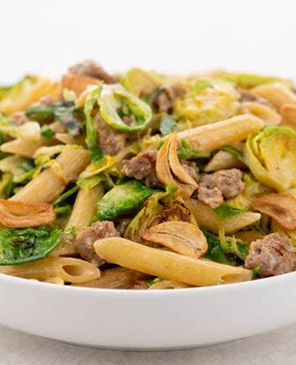 Italian Sausage Pasta with Brussels Sprouts and garlic chips