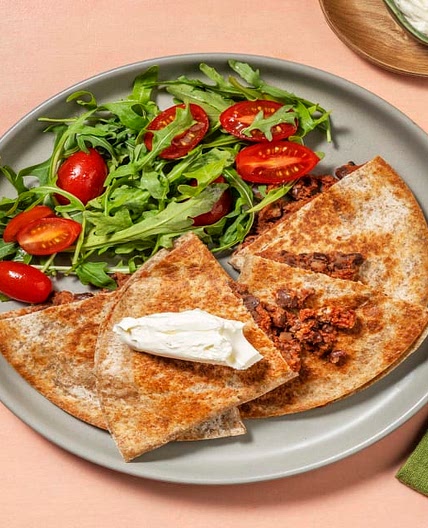 Cheesy Chipotle Bean Quesadillas with Tomato & Rocket Salad and Soured Cream