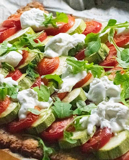 Courgette and tomato tart with burrata and rocket