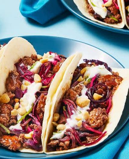 Sweet Chili Pork Tacos with Red Cabbage Slaw, Zesty Crema & Peanuts