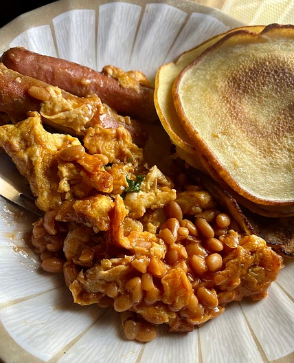 Pancakes and shrimp fried eggs with chicken sausage.