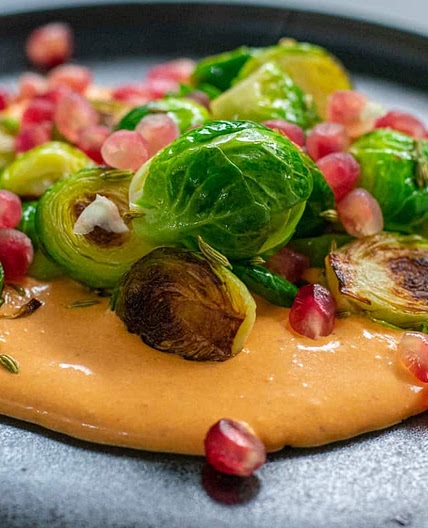 Caramelised Brussels sprouts with whipped harissa feta, fennel and pomegranate seeds