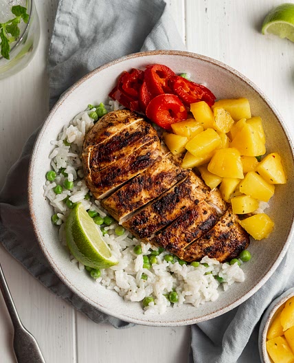 Jerk chicken with creamy coconut rice, peas and mango