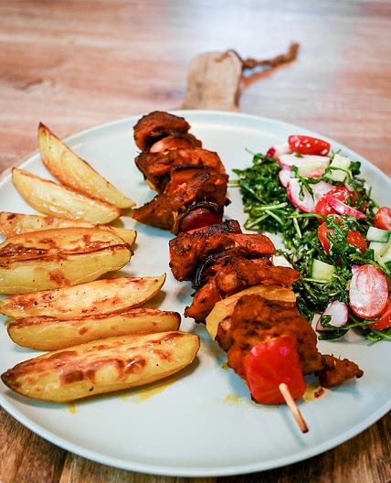 Pork Skewers With Baked Potatoes And Vegetable Salad