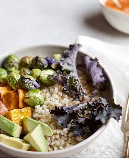Carrot-ginger apple cider vinaigrette on a sweet potato avo bowl