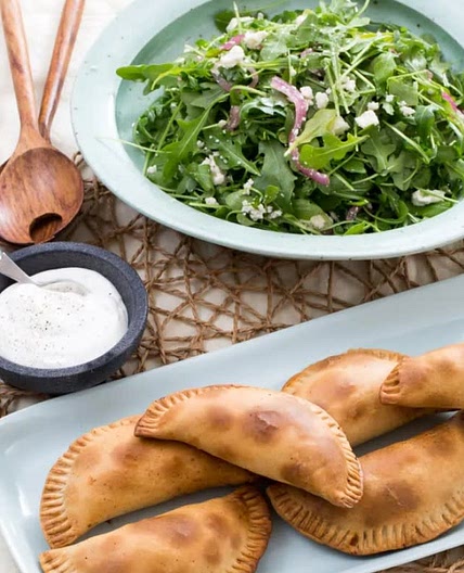 Baked Empanadas de Picadillo with Arugula, Queso Fresco & Pickled Onion Salad