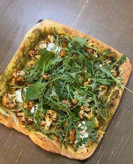 Cauliflower and lemon pesto pizza with baby greens