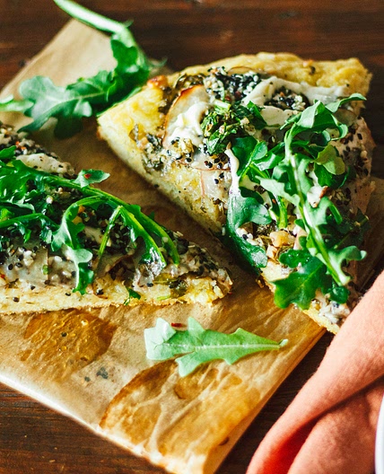 Crispy Seasoned Potato Pesto Pizza with Cashew Mozzarella Cream and Arugula on an Herbed Crust