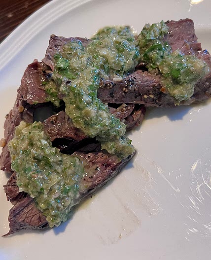 Sliced skirt steak with parsley caper sauce