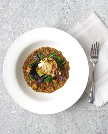 Lentil stew with sweet potatoes, wilted spinach and roasted cabbage