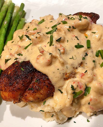 BLACKENED CATFISH TOPPED WITH A CRAWFISH CREAM SAUCE